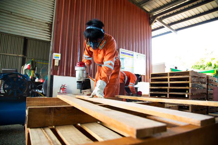 Professional worker manufacturing wooden pallets at Misarma Enterprise
